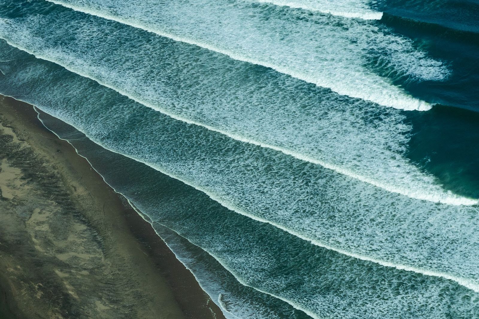 Aerial view of Atlantic surf lines meeting the Namib desert shore